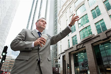 picture of someone hailing a taxi - Businessman hailing a cab in city Stock Photo - Premium Royalty-Free, Code: 6122-08212556