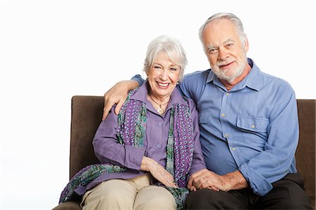 Senior couple on sofa against white background Stock Photo - Premium Royalty-Free, Code: 6122-08212563