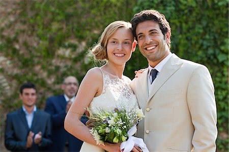 simsearch:614-05399399,k - Newlyweds at marriage ceremony, looking away Photographie de stock - Premium Libres de Droits, Code: 6122-08212503