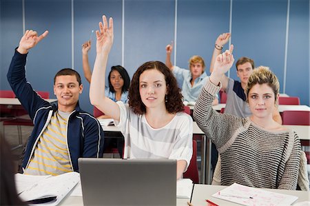 University students holding up hands in class Stock Photo - Premium Royalty-Free, Code: 6122-08212687