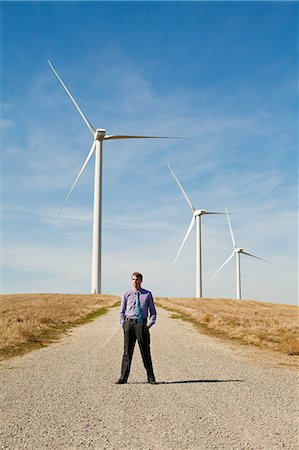 Man in front of wind turbines Stock Photo - Premium Royalty-Free, Code: 6122-08212754