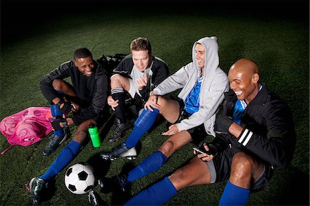 simsearch:6122-07697777,k - Soccer team resting on pitch after game Photographie de stock - Premium Libres de Droits, Code: 6122-08212778