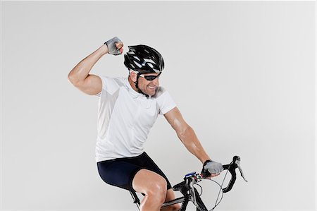Male cyclist cheering Stock Photo - Premium Royalty-Free, Code: 6122-08212816