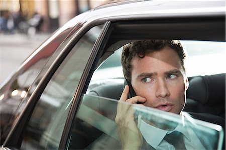 Businessman in car on cellphone Stock Photo - Premium Royalty-Free, Code: 6122-08212832