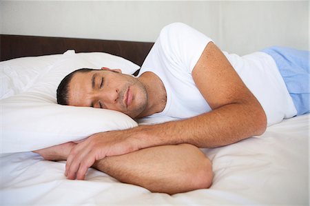 Man asleep on bed Stock Photo - Premium Royalty-Free, Code: 6122-08229145