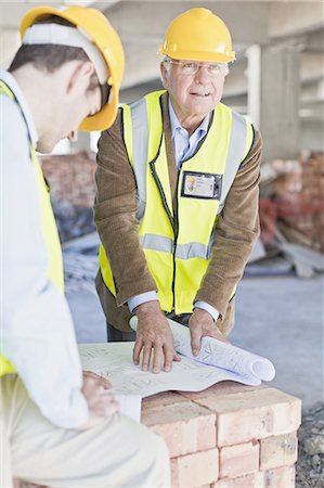 Businessman and worker with blueprints Stock Photo - Premium Royalty-Free, Code: 6122-08229246