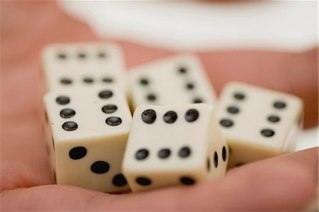 Close up of woman holding dice Stock Photo - Premium Royalty-Free, Code: 6122-08229390