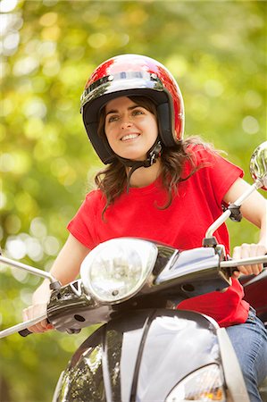 pictures of people riding scooters - Woman riding scooter in park Stock Photo - Premium Royalty-Free, Code: 6122-08229414