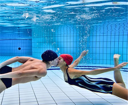 Couple kissing in swimming pool Stock Photo - Premium Royalty-Free, Code: 6122-08229563