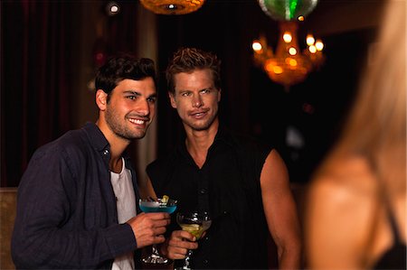 simsearch:649-06040177,k - Smiling men having cocktails in club Stock Photo - Premium Royalty-Free, Code: 6122-08229502