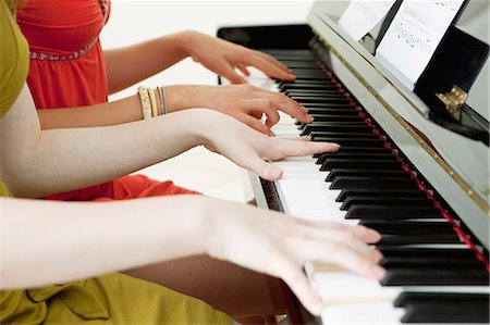Teenage girls playing piano together Stock Photo - Premium Royalty-Free, Code: 6122-08229697