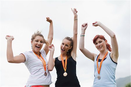 simsearch:6122-08229154,k - Cheering women wearing medals in park Stockbilder - Premium RF Lizenzfrei, Bildnummer: 6122-08229615