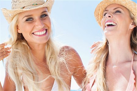 simsearch:6122-08229746,k - Women laughing together on beach Stock Photo - Premium Royalty-Free, Code: 6122-08229745