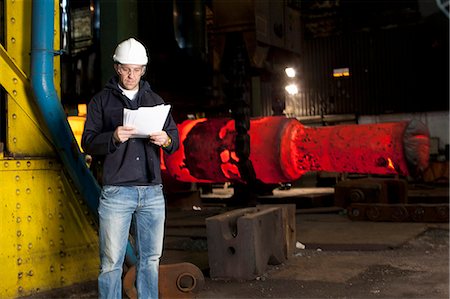 sheffield - Worker reading papers in steel forge Stock Photo - Premium Royalty-Free, Code: 6122-08229783