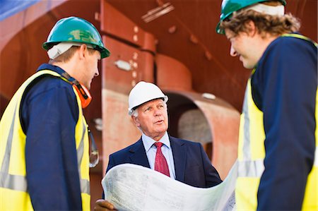 simsearch:6122-08229062,k - Workers reading blueprints on dry dock Stock Photo - Premium Royalty-Free, Code: 6122-08229877