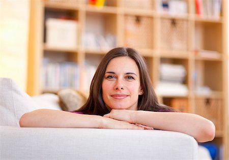 simsearch:6122-08229162,k - Smiling woman relaxing on sofa Stock Photo - Premium Royalty-Free, Code: 6122-08229921