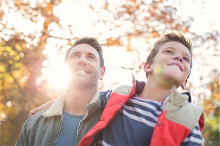 simsearch:6124-08170418,k - Father in son below sunny autumn tree Stock Photo - Premium Royalty-Free, Code: 6124-08170344