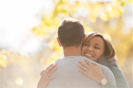 Enthusiastic couple hugging outdoors Stock Photo - Premium Royalty-Free, Code: 6124-08170393