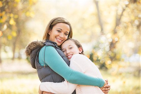 simsearch:6124-08170436,k - Portrait of smiling mother and daughter hugging outdoors Stock Photo - Premium Royalty-Free, Code: 6124-08170407