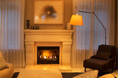 simsearch:6124-08170708,k - Illuminated floor lamp next to marble fireplace Stock Photo - Premium Royalty-Free, Code: 6124-08170583