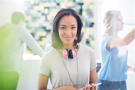 simsearch:6113-07147925,k - Portrait confident creative businesswoman with headphones in office Stock Photo - Premium Royalty-Free, Code: 6124-08170747