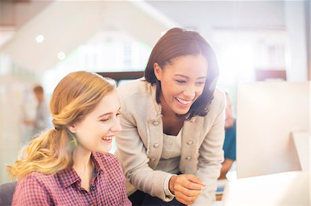 people conference - Smiling businesswoman using computer in sunny office Stock Photo - Premium Royalty-Free, Code: 6124-08170733