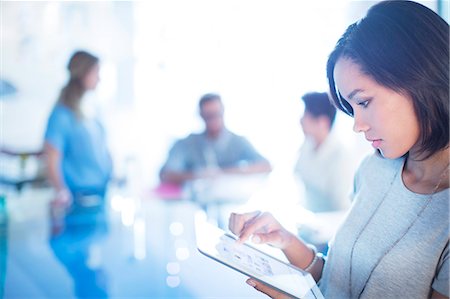 picture of working women - Focused businesswoman using digital tablet Stock Photo - Premium Royalty-Free, Code: 6124-08170731