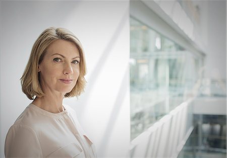 portrait business woman confident - Portrait confident businesswoman in office Stock Photo - Premium Royalty-Free, Code: 6124-08520408