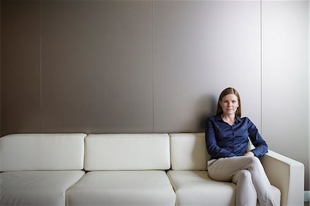 simsearch:632-05604394,k - Portrait confident businesswoman with legs crossed on sofa Stock Photo - Premium Royalty-Free, Code: 6124-08520418