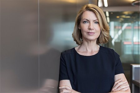 serious standing female - Portrait senior businesswoman with arms crossed Stock Photo - Premium Royalty-Free, Code: 6124-08520431