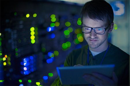 person in a server room - Server room technician using digital tablet Stock Photo - Premium Royalty-Free, Code: 6124-08658162