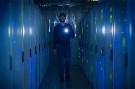 people server - Server room technician with flashlight in dark corridor Stock Photo - Premium Royalty-Free, Code: 6124-08658164