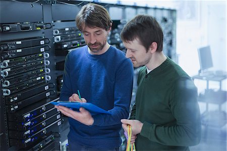Server room technicians with clipboard Stock Photo - Premium Royalty-Free, Code: 6124-08658176