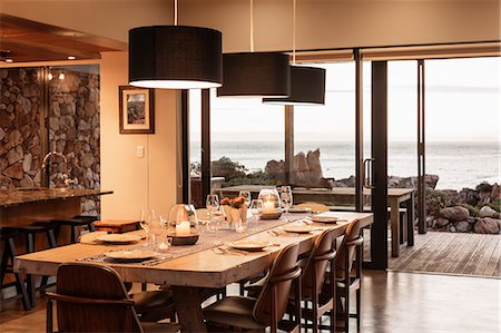 Home showcase dining room overlooking ocean Stock Photo - Premium Royalty-Free, Code: 6124-08658109