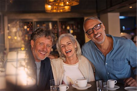 simsearch:6124-08743227,k - Portrait laughing friends drinking coffee in restaurant Stock Photo - Premium Royalty-Free, Code: 6124-08743182