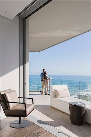 simsearch:6124-08743307,k - Couple enjoying sunny ocean view from luxury home showcase balcony Stock Photo - Premium Royalty-Free, Code: 6124-08743340