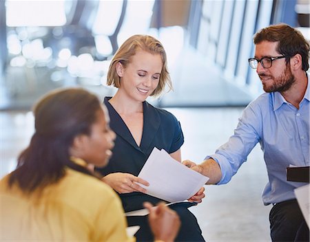 Business people discussing paperwork in meeting Stock Photo - Premium Royalty-Free, Code: 6124-08768363