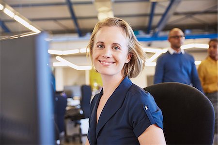 simsearch:6124-08768414,k - Portrait smiling businesswoman working at computer Stock Photo - Premium Royalty-Free, Code: 6124-08768380