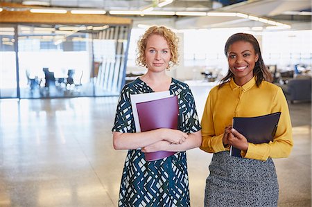 simsearch:6124-08768365,k - Portrait smiling businesswomen in office Foto de stock - Sin royalties Premium, Código: 6124-08768410