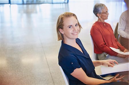 Portrait smiling businesswoman in meeting Stock Photo - Premium Royalty-Free, Code: 6124-08768422