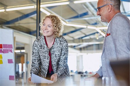 simsearch:6124-08768390,k - Smiling businesswoman leading meeting in conference room Stock Photo - Premium Royalty-Free, Code: 6124-08768427