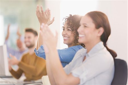 people clapping - Businesswomen smiling and clapping in meeting Stock Photo - Premium Royalty-Free, Code: 6124-08703875