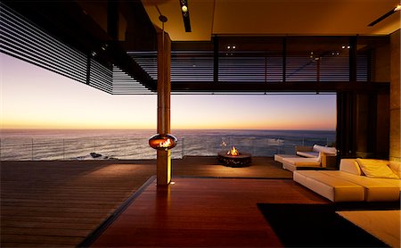 simsearch:6113-07543354,k - Fire pit and hanging fireplace on modern luxury patio with sunset ocean view Foto de stock - Sin royalties Premium, Código: 6124-08703993