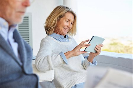 side view of senior with computer - Senior woman using digital tablet on patio Stock Photo - Premium Royalty-Free, Code: 6124-08805198