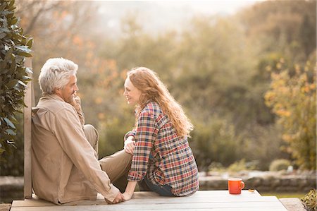 simsearch:6124-08820762,k - Affectionate couple talking and drinking coffee on autumn patio Stock Photo - Premium Royalty-Free, Code: 6124-08820745