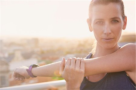 fitness-tracker - Close up portrait determined female runner stretching arms Stockbilder - Premium RF Lizenzfrei, Bildnummer: 6124-08820787