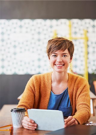 simsearch:6124-08743227,k - Portrait smiling businesswoman using digital tablet drinking coffee at cafe table Stock Photo - Premium Royalty-Free, Code: 6124-08820796