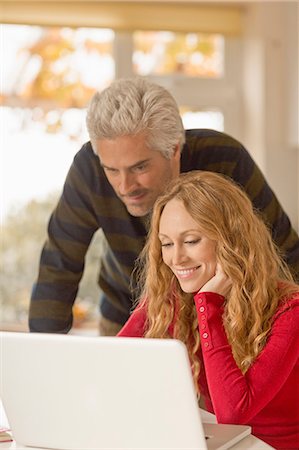 simsearch:6113-06753237,k - Couple using laptop at home Stock Photo - Premium Royalty-Free, Code: 6124-08820723