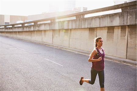 simsearch:649-06716525,k - Female runner running on sunny urban street Stockbilder - Premium RF Lizenzfrei, Bildnummer: 6124-08820807