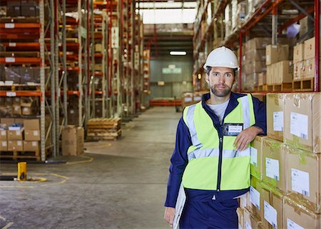 simsearch:614-06719099,k - Portrait confident worker leaning on stacked boxes in distribution warehouse Stock Photo - Premium Royalty-Free, Code: 6124-08820949